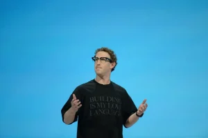 Mark Zuckerberg speaking on stage gesturing with both hands