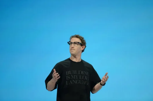Mark Zuckerberg speaking on stage gesturing with both hands