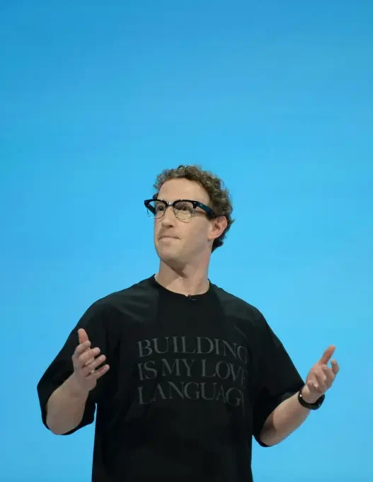 Mark Zuckerberg speaking on stage gesturing with both hands