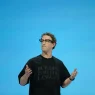 Mark Zuckerberg speaking on stage gesturing with both hands