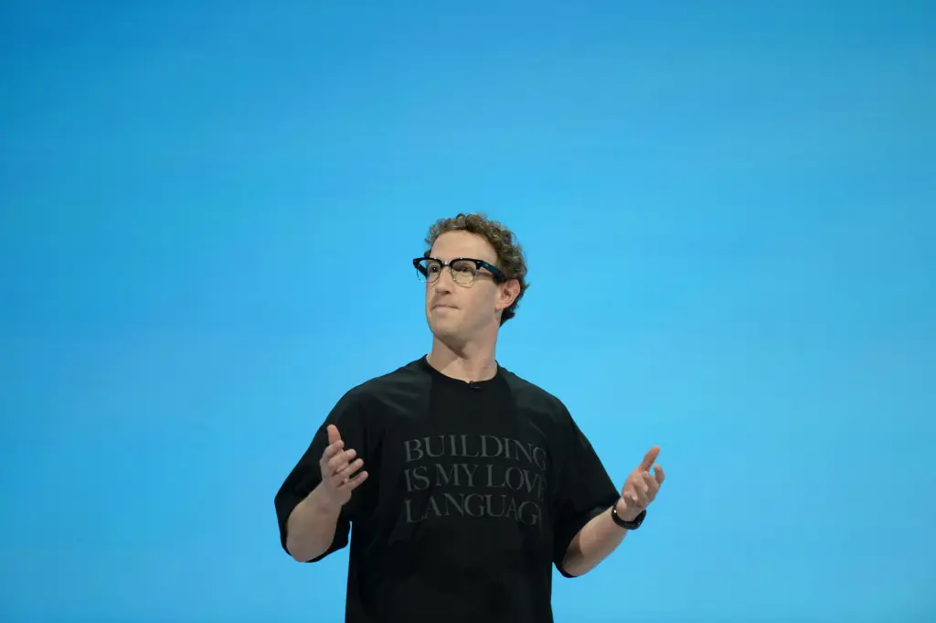 Mark Zuckerberg speaking on stage gesturing with both hands