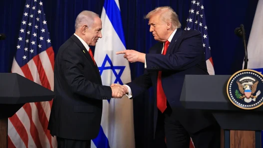 Benjamin Netanyahu and Donald Trump shaking hands at podiums